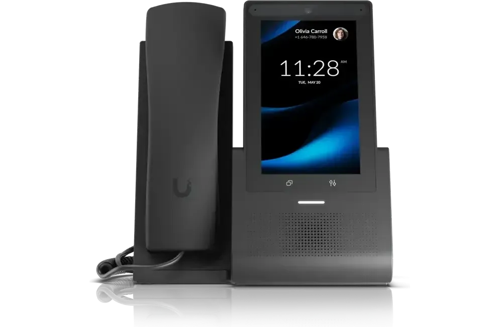A desk phone in its cradle