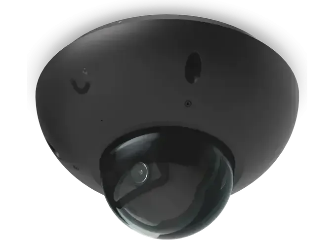 A dome camera from above at three-quarters, the lens visible through the dome