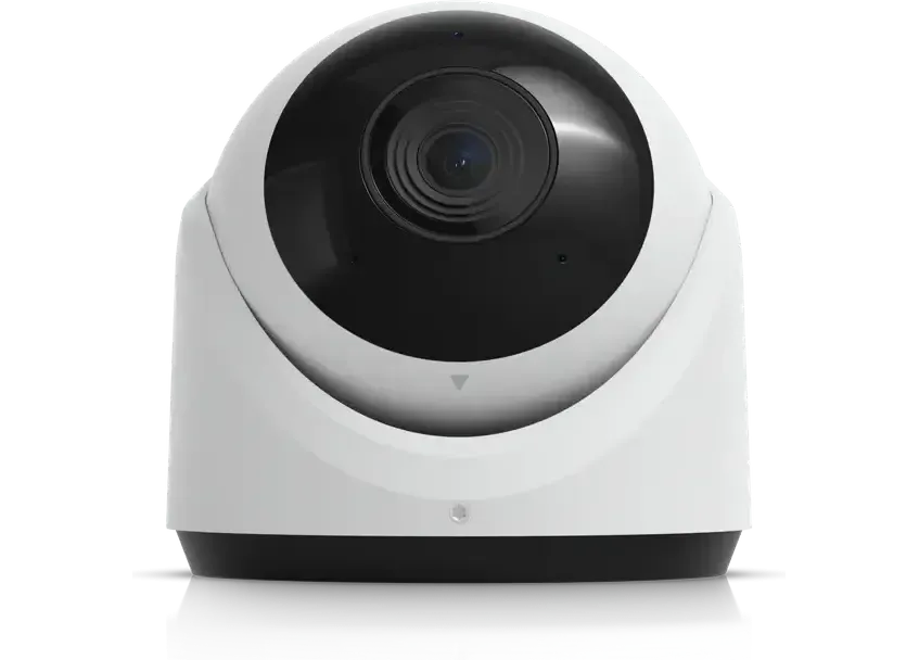 A turret camera photographed near-front, the dark lens filling much of the housing