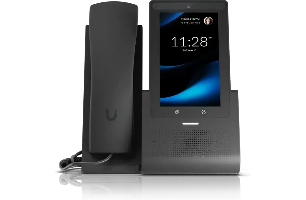 A desk phone in its cradle